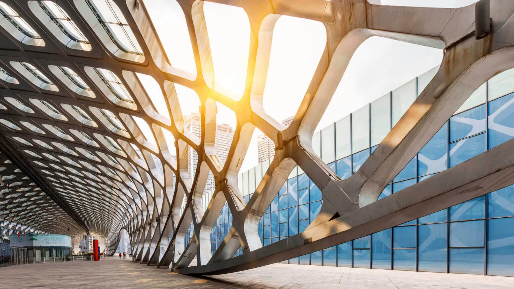 Image of a metal mesh framework artistically warped into a honeycomb walkway in the city to describe Outlook 2023