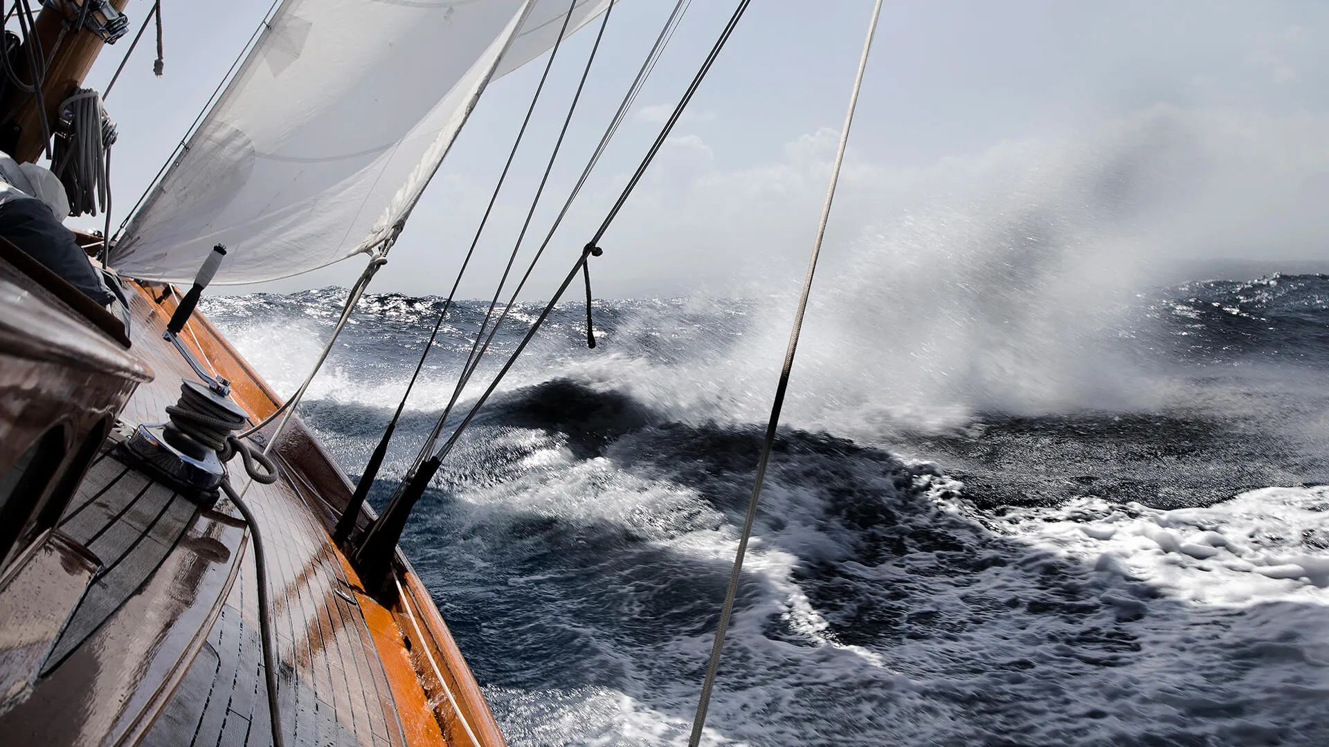 Yacht leaning in rough sea.